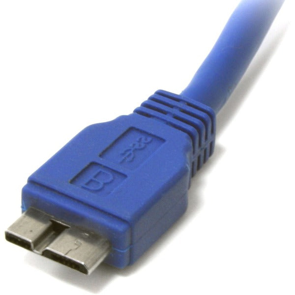 A blue StarTech.com 1 ft SuperSpeed USB 3.0 Cable A to Micro B connected to a white surface.