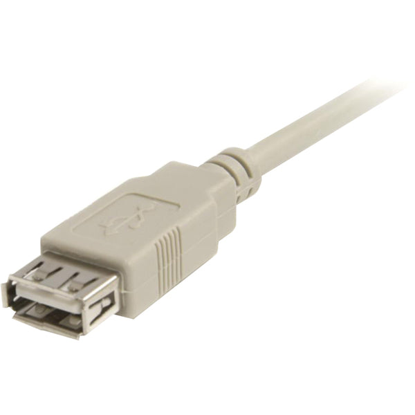 A beige StarTech.com 6 ft USB 2.0 Extension Cable A to A - M/F connected to a computer.