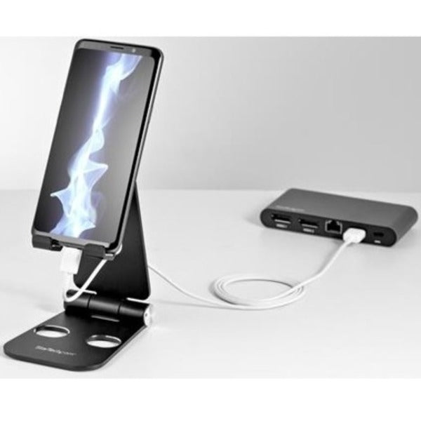 A StarTech.com Phone and Tablet Stand - Foldable Universal Mobile Device Holder - Smartphones/Tablets - Adjustable Cell Phone Stand for Desk with a metal stand.