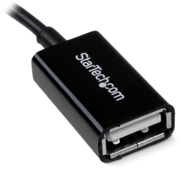 A black StarTech.com 5in Micro USB to USB OTG Host Adapter M/F.