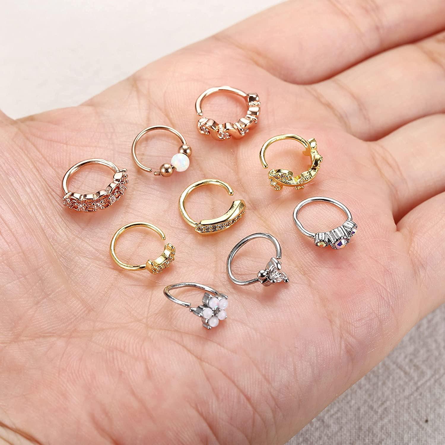 A variety of 9Pcs 20G Stainless Steel Nose Ring Hoop for Women Men in silver, gold, and rose gold tones, each decorated with different elements like pearls, crystals, floral motifs, and cartilage hoop rings.