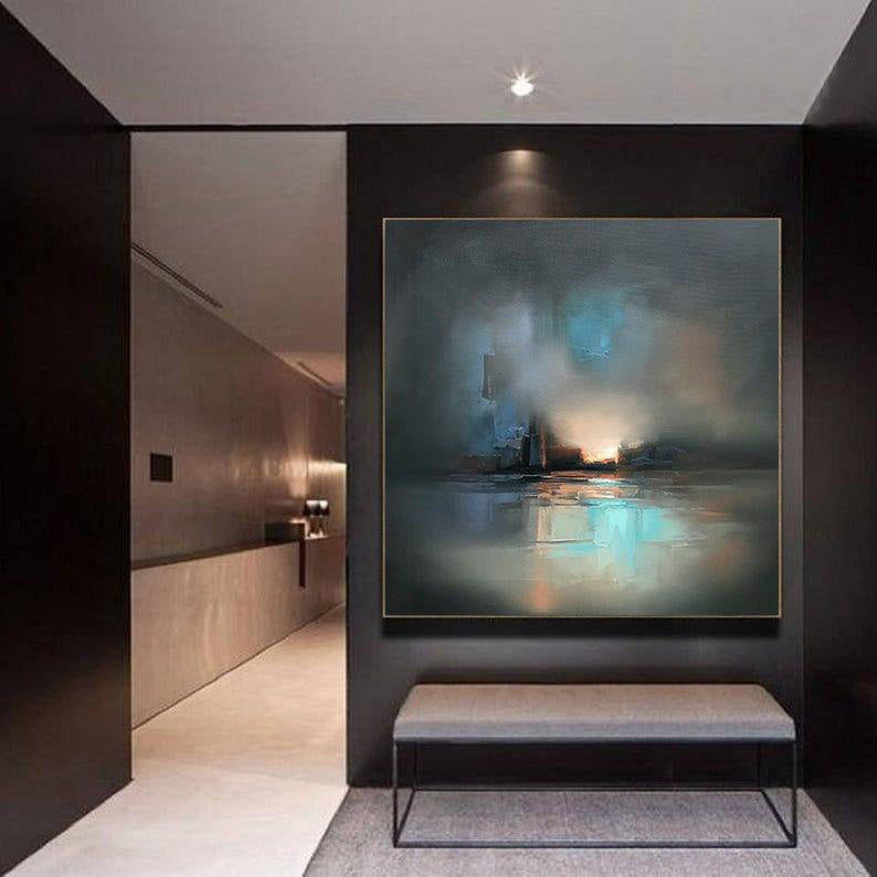 A large hand painted oil painting depicting misty, illuminated ships hangs prominently in a dimly lit, modern room with sleek, dark walls and a bench.
