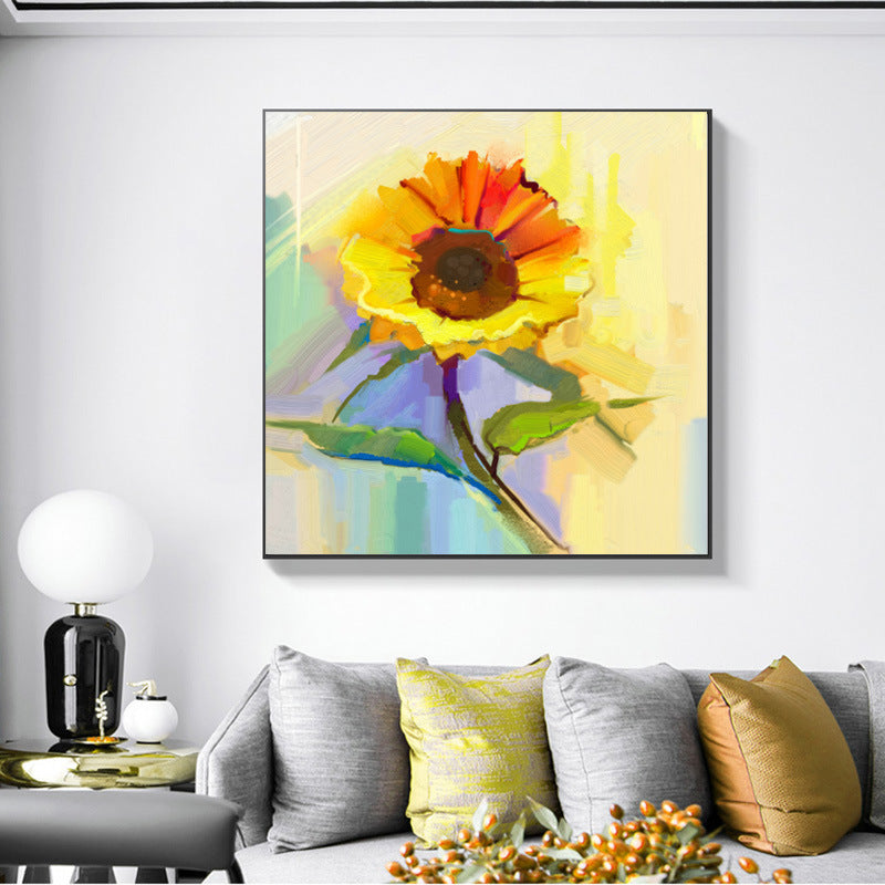 A colorful Modern canvas wall art famous sunflower flower decoration hung above a grey sofa, in a modern living room with grey cabinetry and subtle décor.