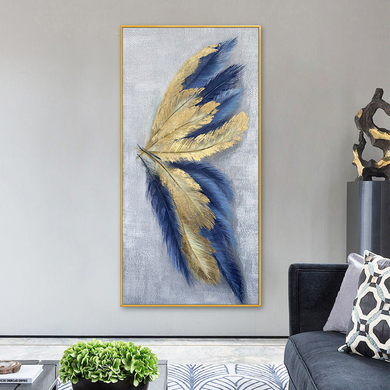 Modern living room with grey walls and a large gold-framed hand painted oil painting of blue and gold feathers, next to a black sofa with a patterned cushion.