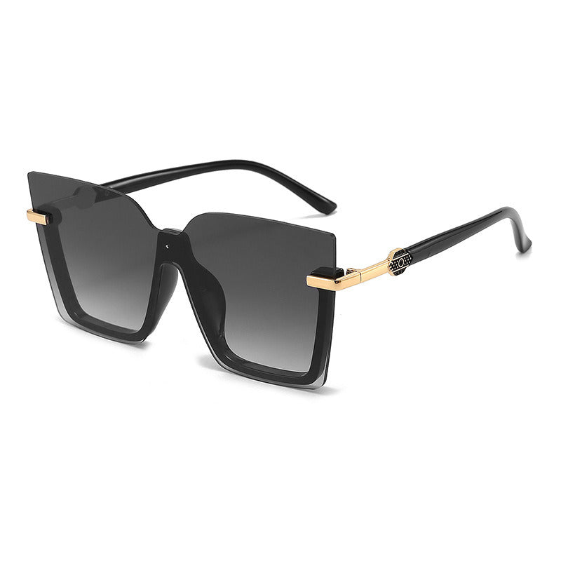 The Sunglasses Ocean Slices Multicolor Personality Trend Sunglasses for Men and Women feature a black oversized square design with gradient lenses, highlighted by thin gold accents on the temples and a small decorative logo near the hinges. These polarized sunglasses offer UV400 protection, making them both stylish and practical for fashion wear.