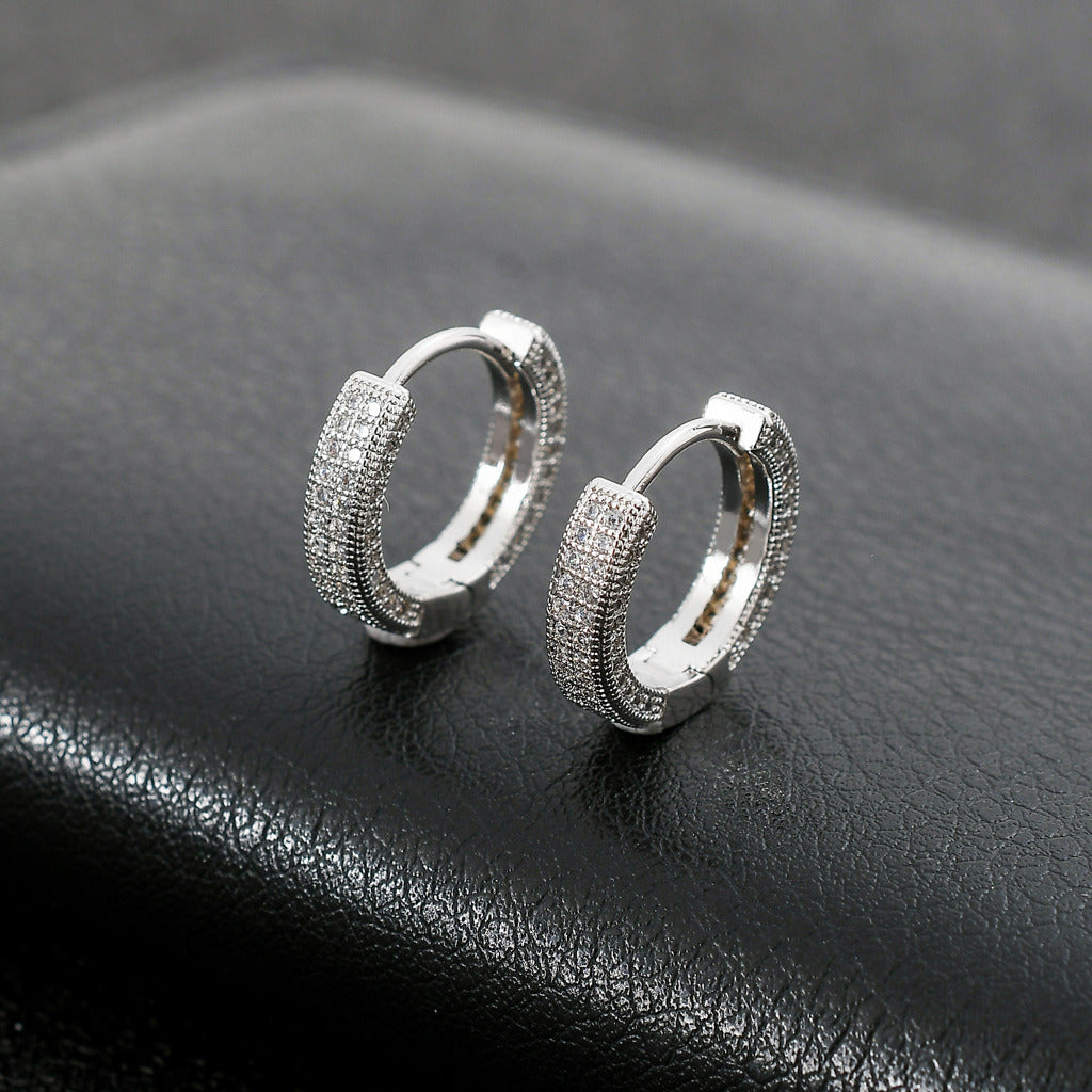 Close-up of a woman's ear wearing a Hoop Earrings Micro Encrusted Zircon Stud Earrings Bling Hip Hop Earrings For Men And Women.