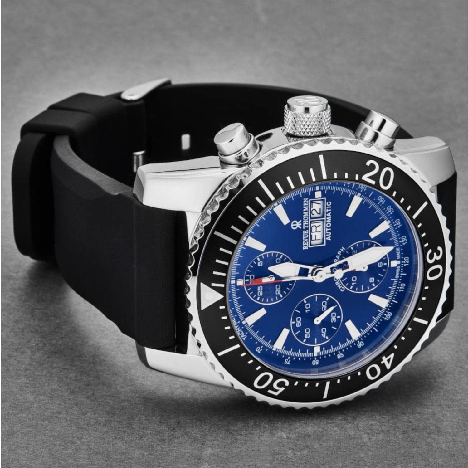 A Revue Thommen 17030.6523 Men's 'Divers' Blue Dial Day-Date Chronograph Rubber Strap Automatic Watch on a white background.