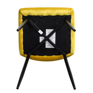 A modern dining room with a white table, four Indoor Velvet Dining Chairs with velvet fabric, and a gray rug, against a blue and white wall with minimalistic artwork.