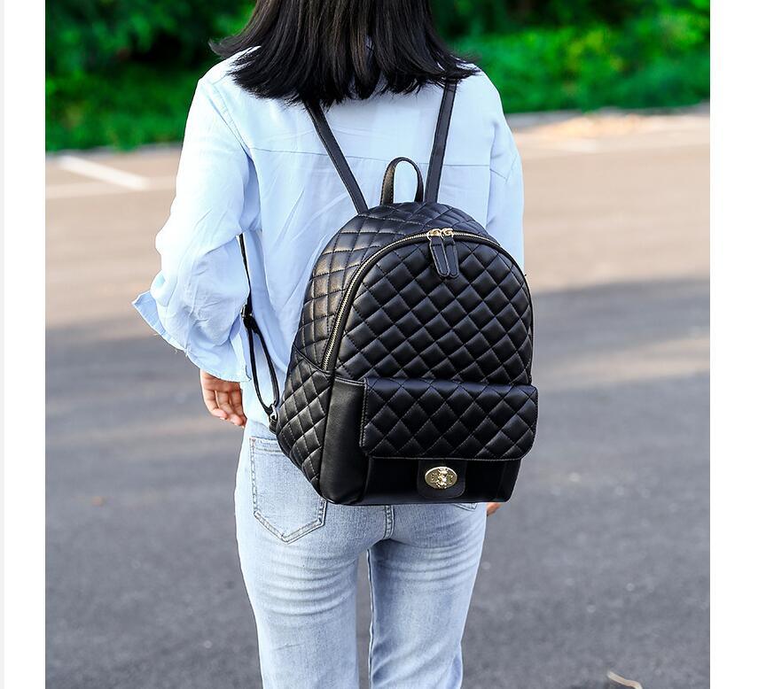 A Doba black leather backpack for men women school college bookbag for student on a white background.