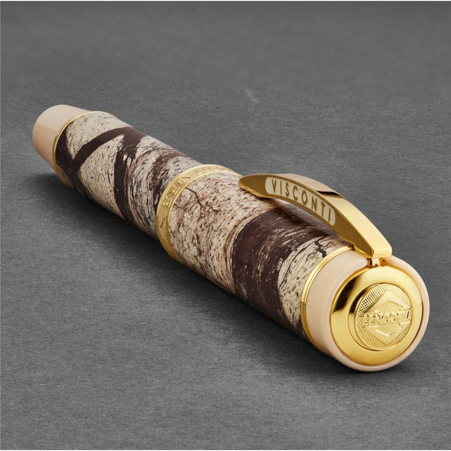 A Visconti 685RL02 'Millionaire' Rain Forest Brown Marble rollerball pen with a camouflage pattern and gold trim.