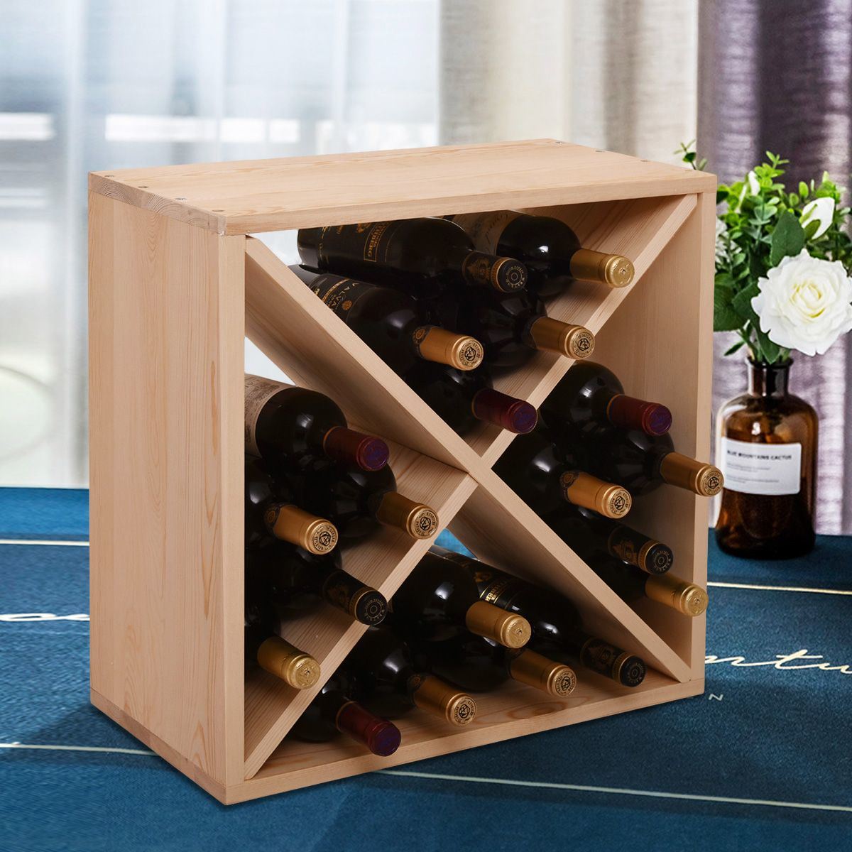 A 24 Bottle Modular Wine Rack, Stackable Wine Storage Cube for Bar Cellar Kitchen Dining Room, Burlywood capable of holding 24 bottles, positioned in front of a blue wall.