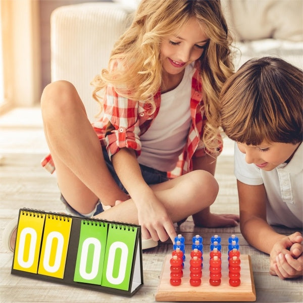 Two children playing with the Lucky Bag - Lucky Chess Piece Set, using score cards for keeping track of their progress.