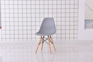 The Set of 4 Modern Style Dining Chairs are mid-century modern side chairs with a black plastic shell lounge design, wooden walnut legs, and metal supports, perfect for your kitchen, dining room, bedroom, or living room.