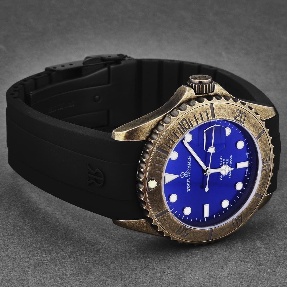 An Revue Thommen Men's 'Diver' Blue Dial Black Rubber Gunmetal Automatic Watch 17571.2885 with a blue dial and black strap.