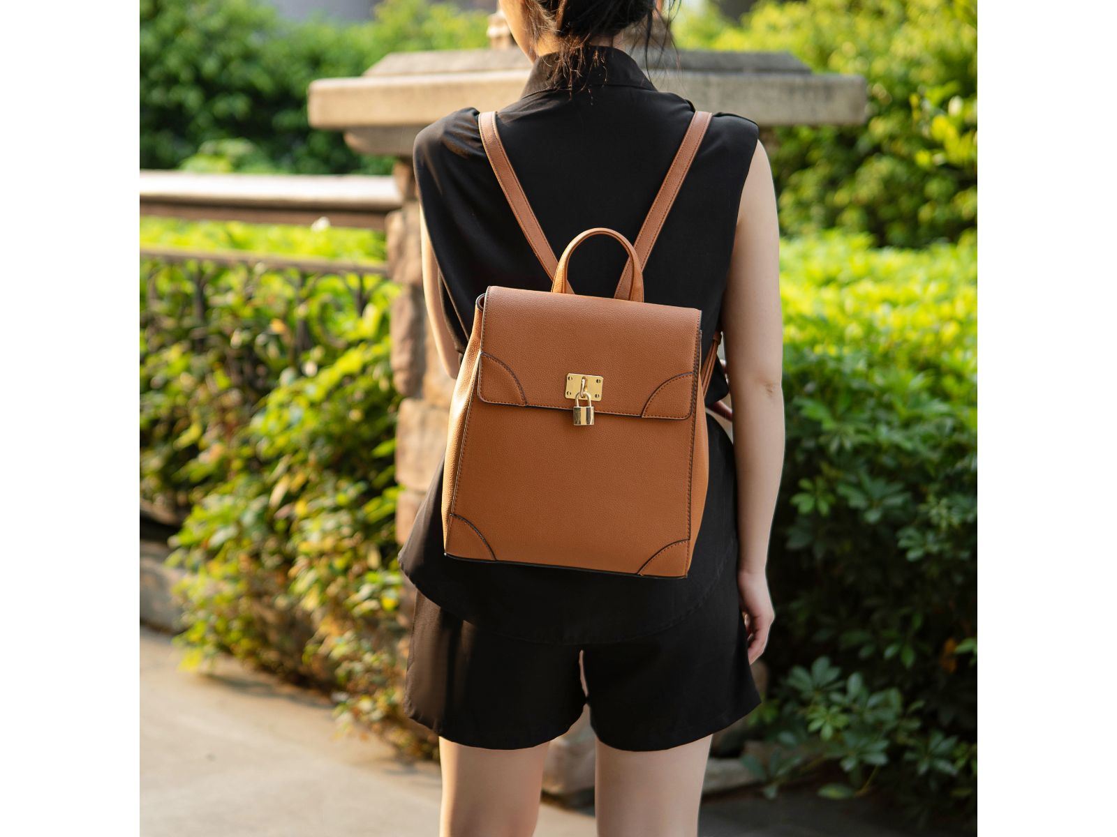 A MKF Collection Sansa Vegan Leather Women's Backpack by Mia k with a gold buckle.