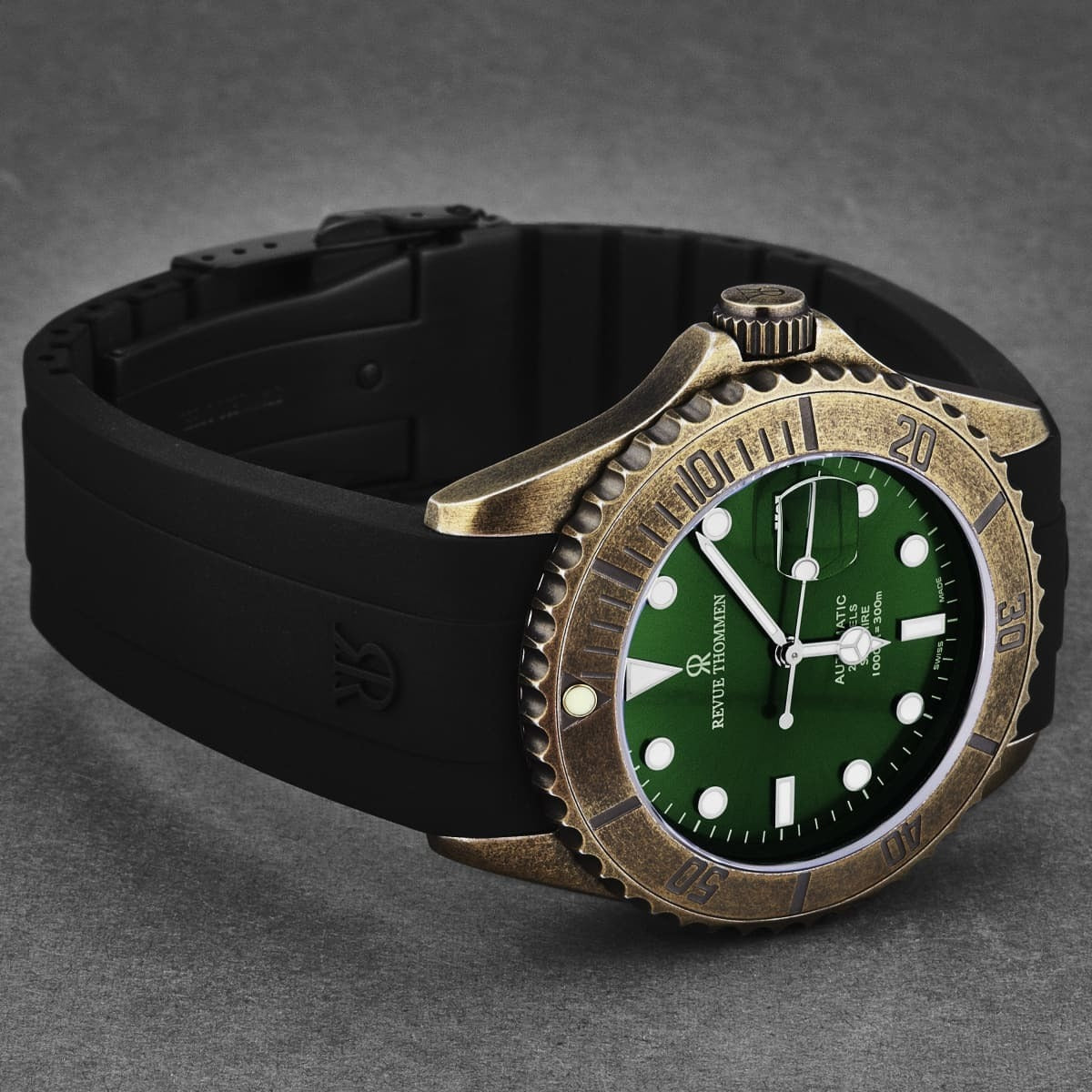 A Revue Thommen Men's 'Diver' Green Dial Black Rubber Gunmetal Automatic Watch 17571.2884 with a green dial and black strap, featuring automatic movement.