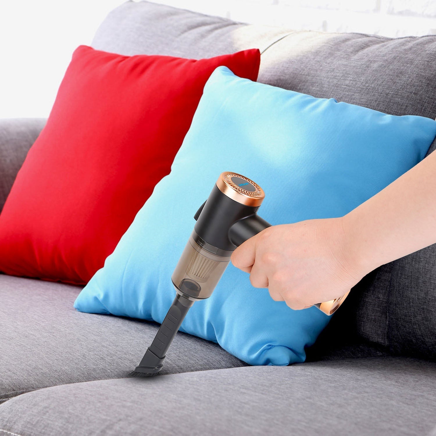 A 120W 9000PA Cordless Handheld Vacuum Cleaner w/ Searchlight with powerful suction, held in hand and attached to a hose.