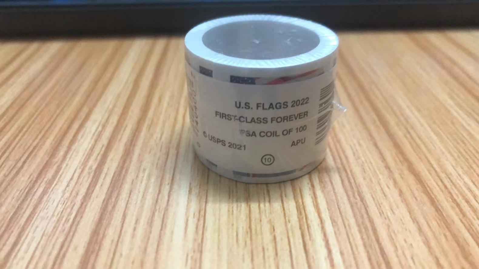 A person is holding a piece of U.S. Flag 2022; 100Pcs/1 Rolls tape that says "u s flags forever.