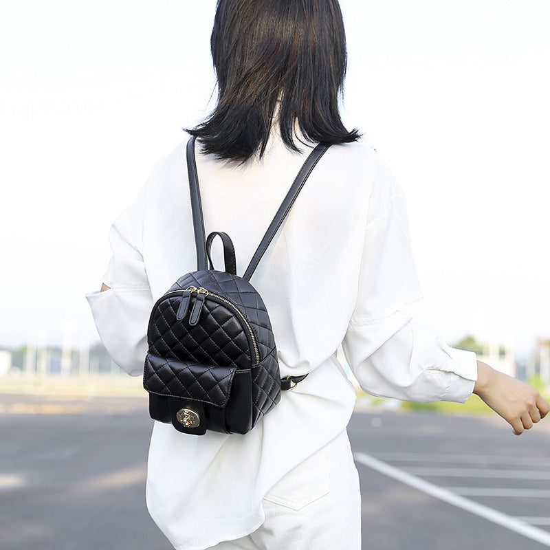 A Doba black leather backpack for men women school college bookbag for student on a white background.