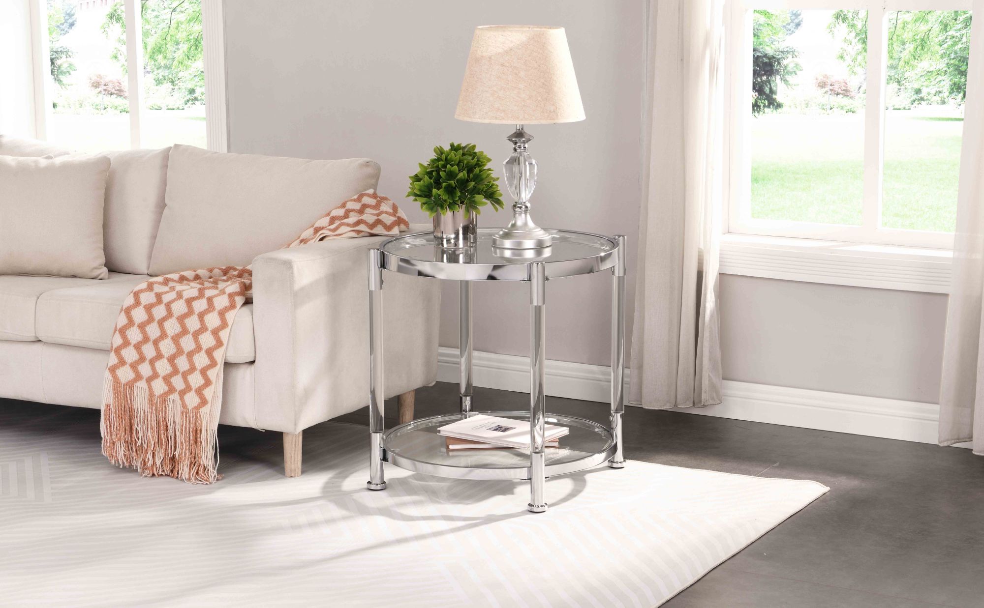 A W82153571 Contemporary Acrylic End Table with chrome legs and a tempered glass top, featuring a lamp on top.