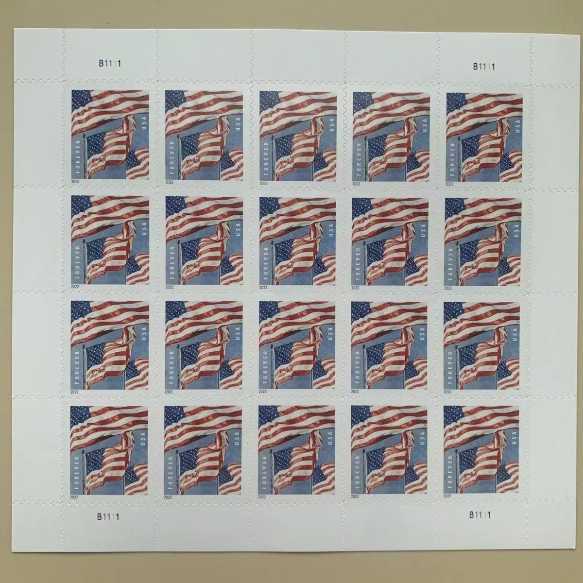 Two sheets of Flag 2022 Sheet- 5 Sheets / 100 Pcs postage stamps lying on a beige surface.