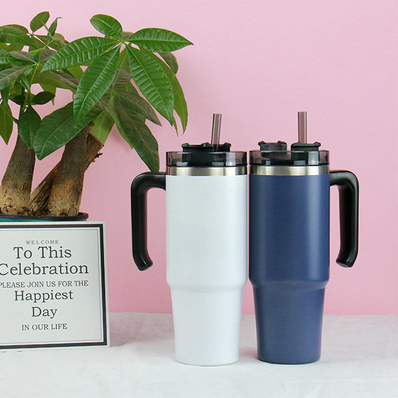 A black insulated 30oz travel car thermo mug with a stainless steel rim and handle, featuring a lid and a straw.