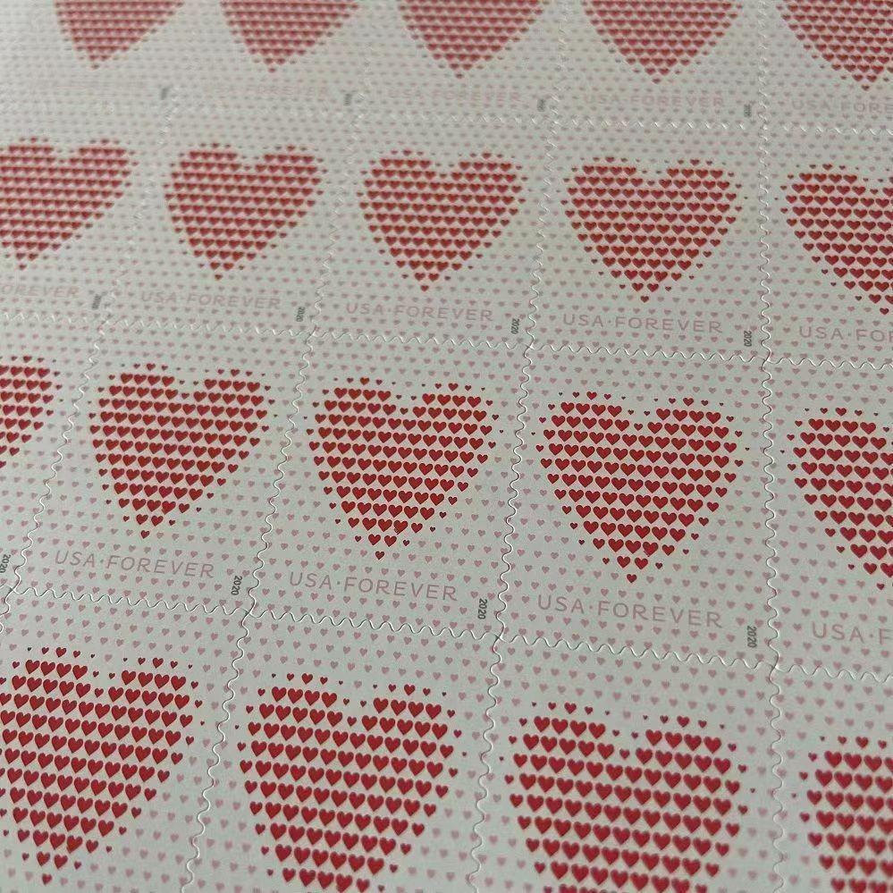 A hand of Made of Hearts 2020 - 5 Sheets / 100 Pcs fanned out on a green surface, each showing a suit of hearts visible from the corner, with details made of hearts.