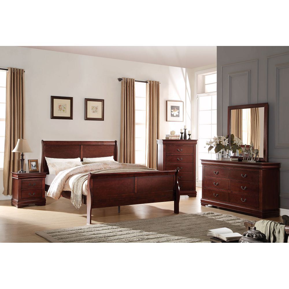 A bedroom set with a bed, dresser and Louis Philippe Mirror in Cherry YJ.