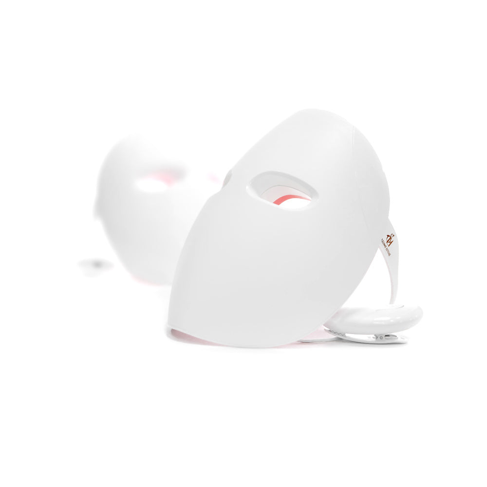 A Made in KOREA LED face mask light therapy led mask red light IR photon skin rejuvenation on a table next to a box for LED photon light therapy.