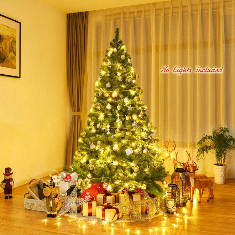 An eye-catching man is standing next to a 6/7.5/9ft Premium Artificial Hinged PVC Christmas Tree with Metal Stand.