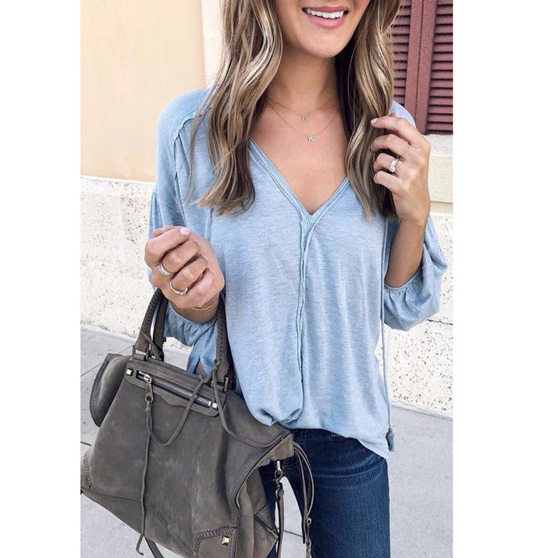 Woman in New Women Deep V-neck Long Sleeve Blouse Casual Tunic Top Solid Color Patchwork Cotton Shirt, holding a gray handbag, smiling slightly in both images, which only show her from the chest up.