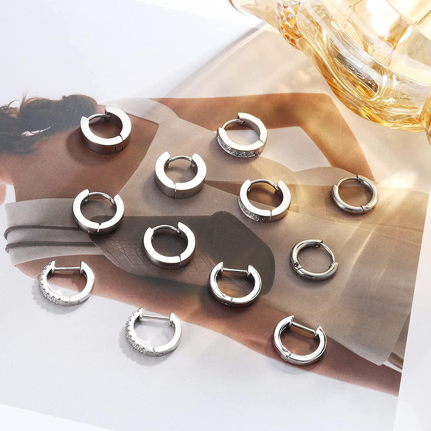 A collection of twelve 6Pairs Huggie Hoop Earrings for Women Men 14K Gold Plated Cubic Zirconia Small Hoop Earrings Tiny Cartilage Helix Daith Earrings Minimalist Ear Piercing Sets in various designs, some plain and others adorned with tiny rhinestones, displayed on a white background.