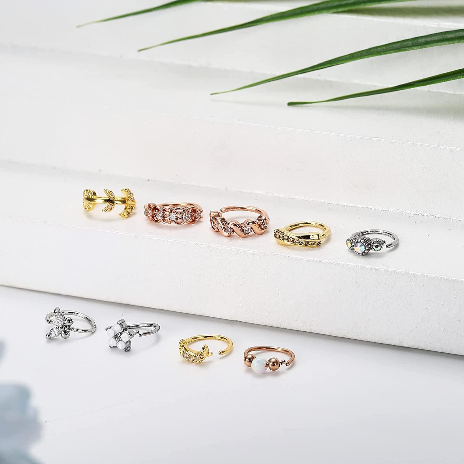 A variety of 9Pcs 20G Stainless Steel Nose Ring Hoop for Women Men in silver, gold, and rose gold tones, each decorated with different elements like pearls, crystals, floral motifs, and cartilage hoop rings.