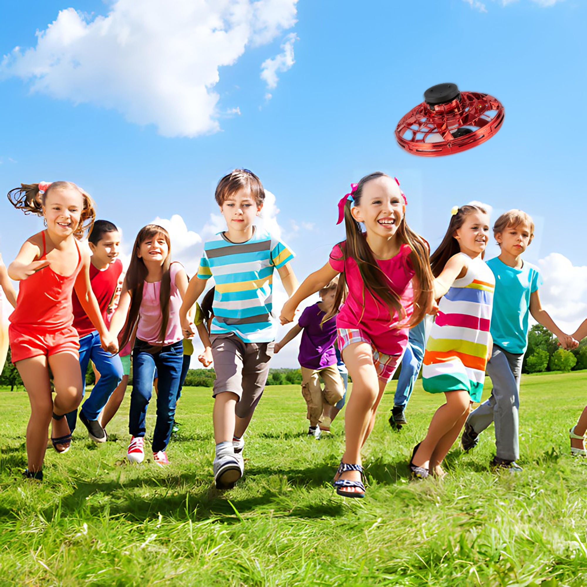 Children playing tag in a lush green park, with one girl in blue shorts reaching to tag a boy in a striped shirt, while a Glow Drone 360 Flying Toy with LED lights hovers above.