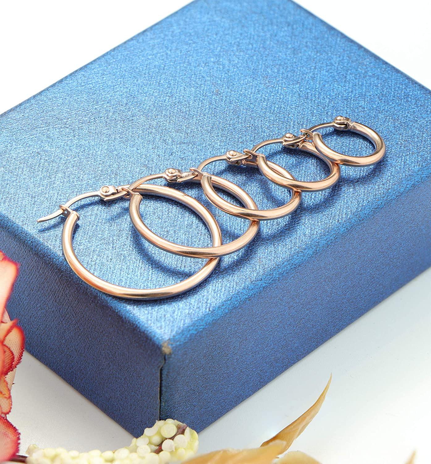Four pairs of Stainless Small Hoop Earrings Clasp Gold Plated Hoop Rounded Earrings, ideal for sensitive skin, displayed in varying sizes in a vertical arrangement on a white background.