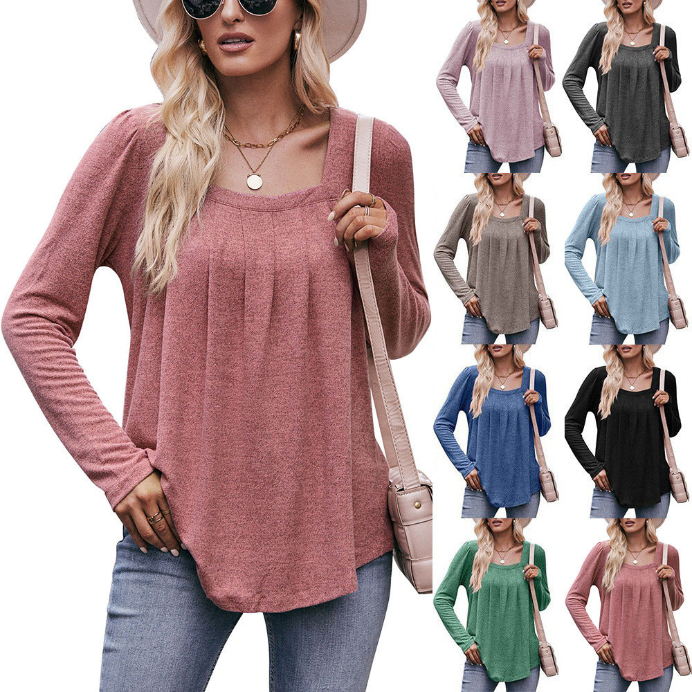 Woman in a Women Long Sleeve Shirt Lightweight Crew Neck Casual Tunic Top 8 Colors and skinny jeans, wearing sunglasses and a white hat, carrying a beige shoulder bag, standing in a quaint street.