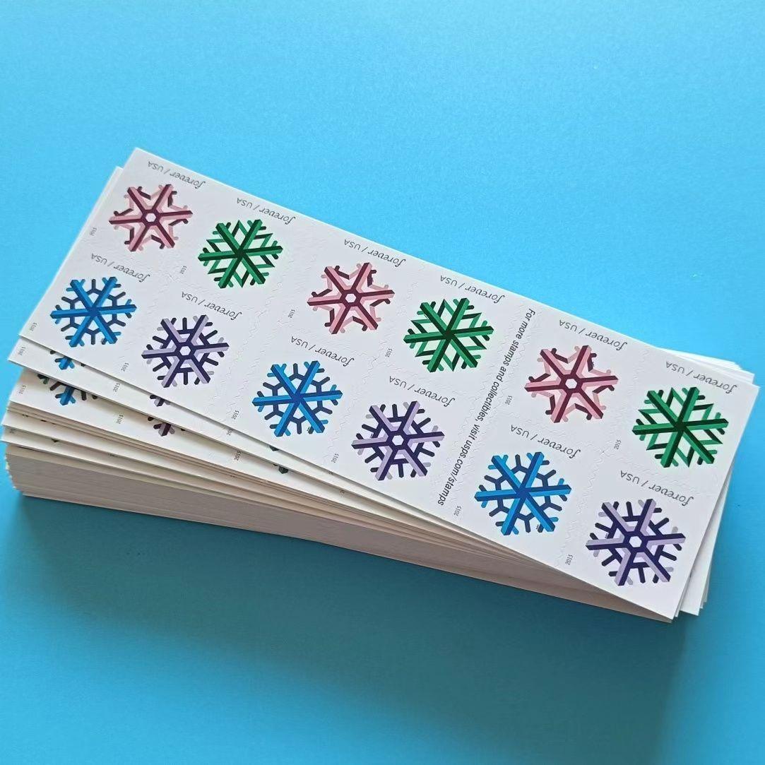 A sheet of Geometric Snowflakes 2015 postage stamps with colorful geometric snowflake designs against a light blue background.