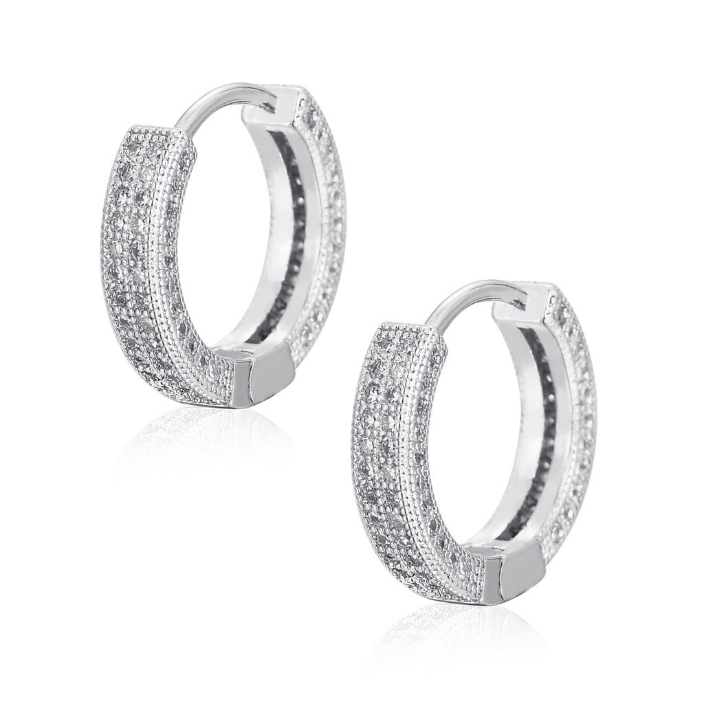 Close-up of a woman's ear wearing a Hoop Earrings Micro Encrusted Zircon Stud Earrings Bling Hip Hop Earrings For Men And Women.