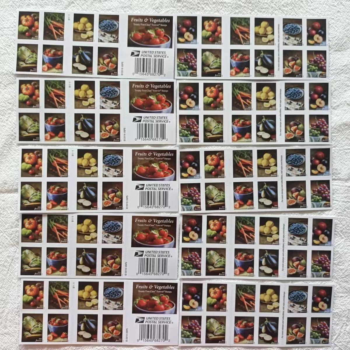 A sheet of Fruits and Vegetables 2020 - 5 Booklets / 100 Pcs stamp booklets featuring colorful images of various fruits and vegetables on a wooden table.