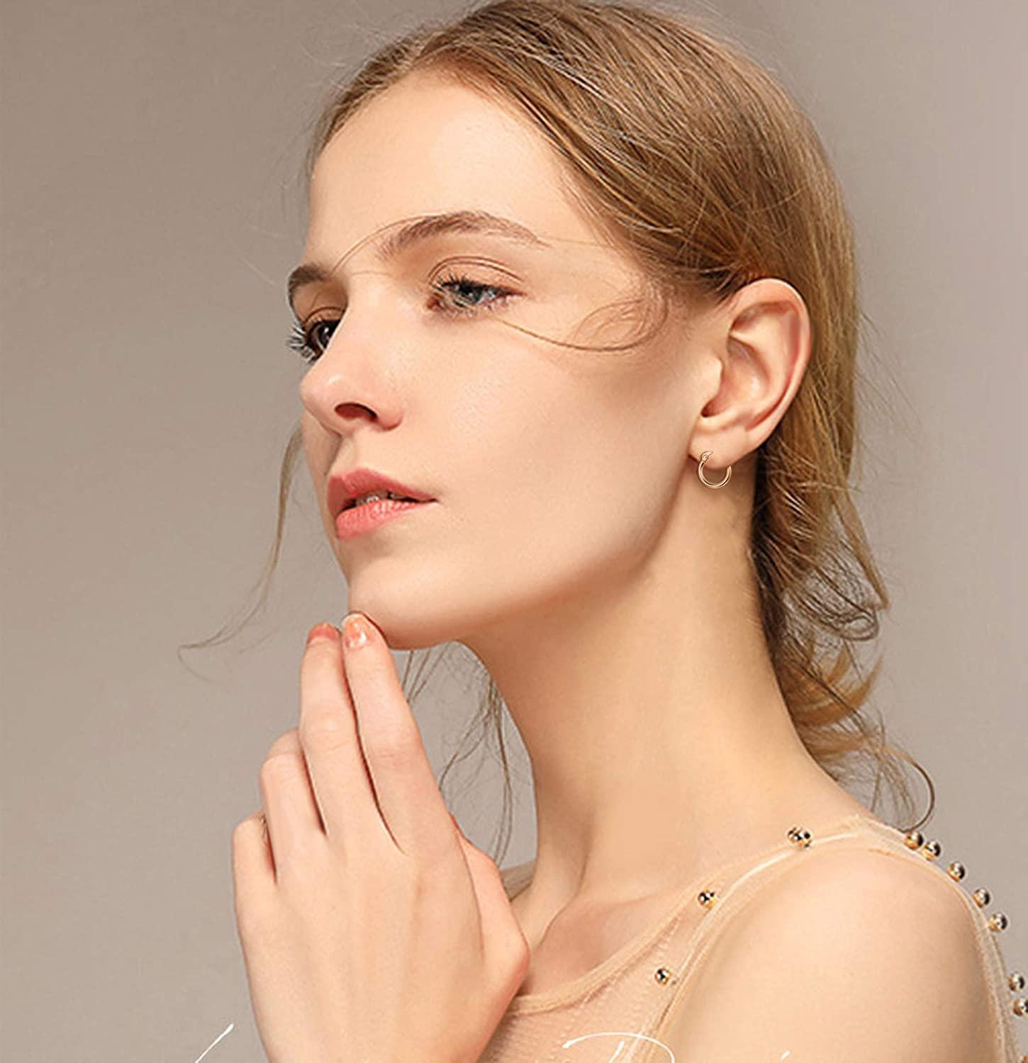 Four pairs of Stainless Small Hoop Earrings Clasp Gold Plated Hoop Rounded Earrings, ideal for sensitive skin, displayed in varying sizes in a vertical arrangement on a white background.