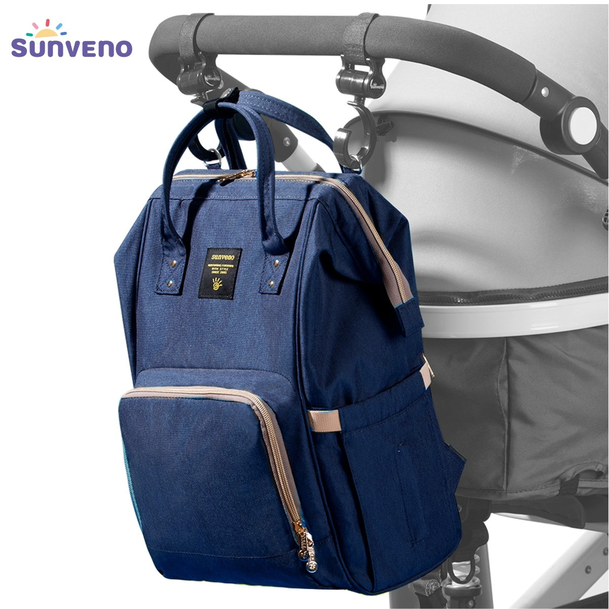 This Sunveno Original Diaper Bag Travel Baby Bags Navy Blue Mommy Backpack Organizer Nappy Maternity Bag Mother Kids, with gold zippers, features an external USB charging port connected to a smartphone for convenient on-the-go charging. Perfect for those who value both style and functionality in their accessories.