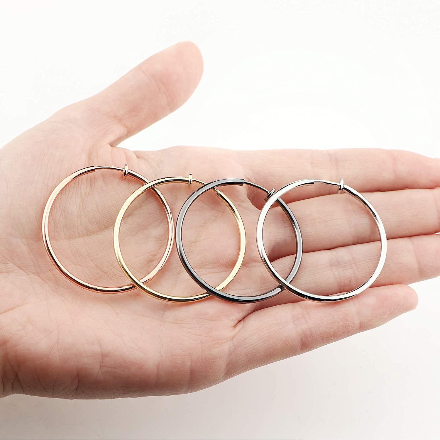 Sentence with replaced product name: 4 Pairs Stainless Fake Hoop Earrings for Woman Men Big Clip On Hoop Earrings Set Non-Pierced Ear, available in gold, rose gold, silver, and black, displayed in pairs, isolated on a white background.