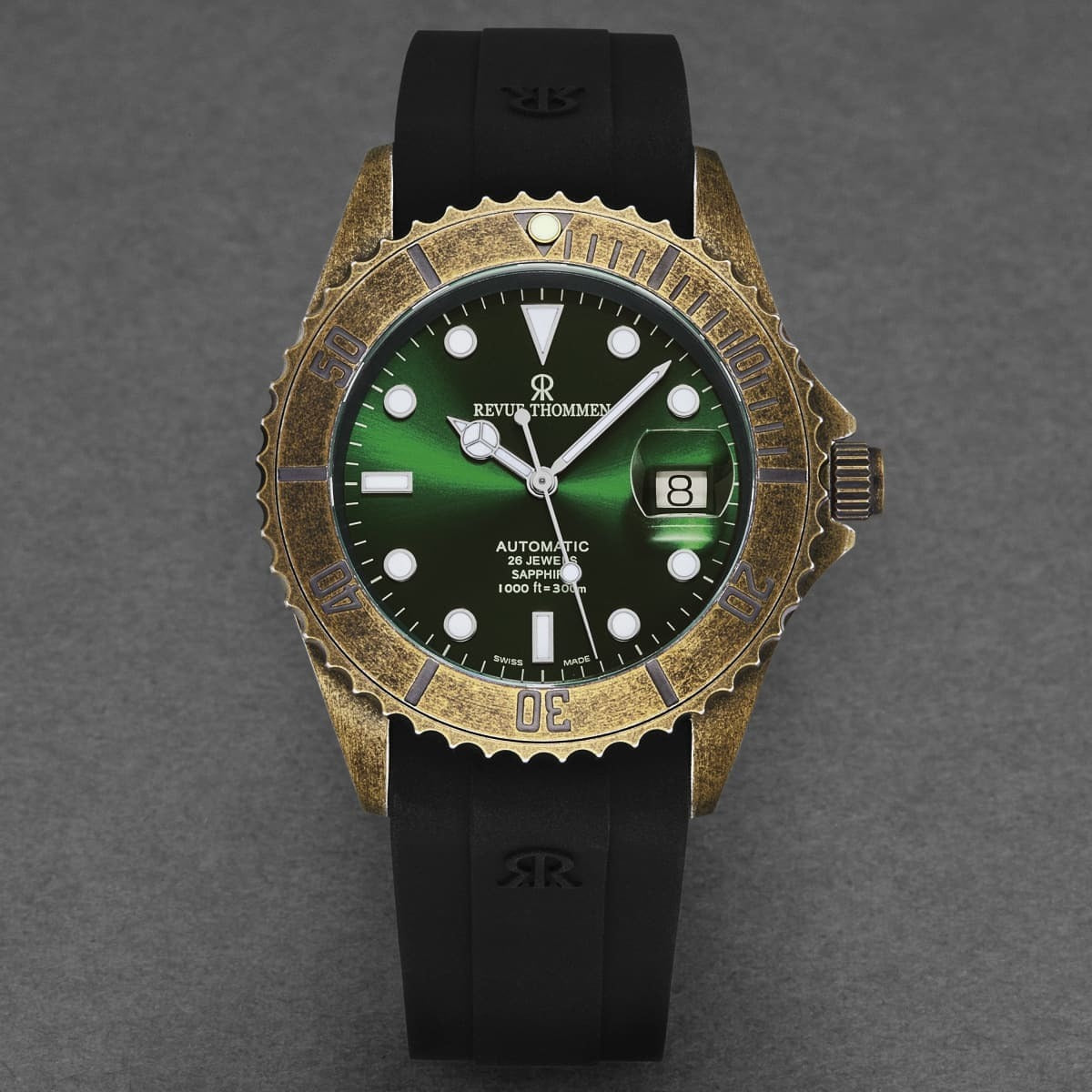 A Revue Thommen Men's 'Diver' Green Dial Black Rubber Gunmetal Automatic Watch 17571.2884 with a green dial and black strap, featuring automatic movement.