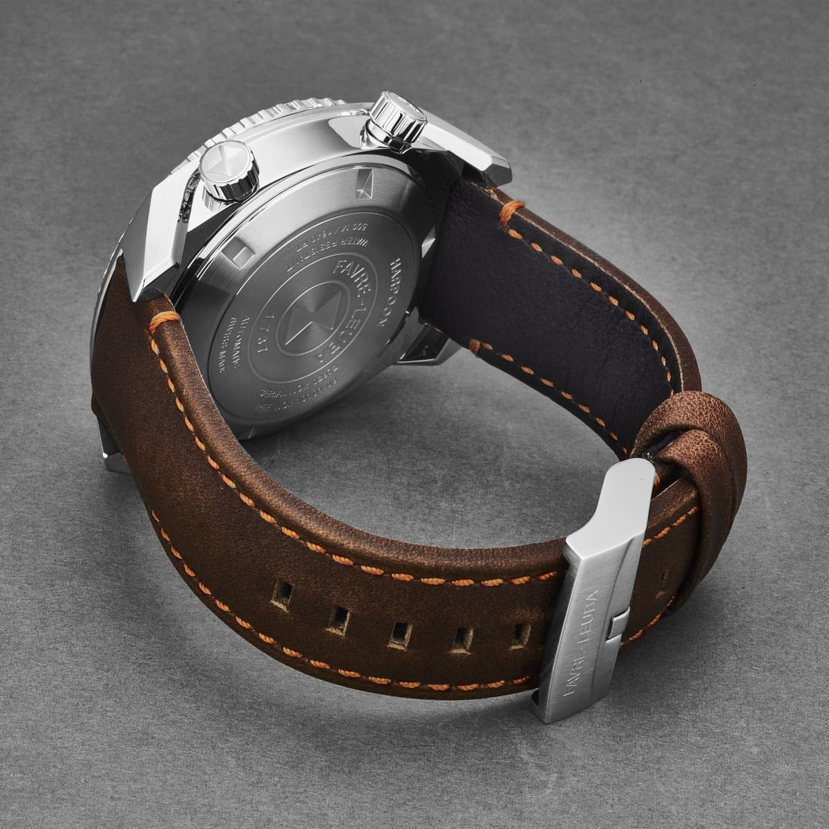 An Favre-Leuba Men's 00.10101.08.13.44 'Raider Harpoon' Black White Dial Brown Leather Strap Automatic Watch, with a black and orange color scheme set against a white background