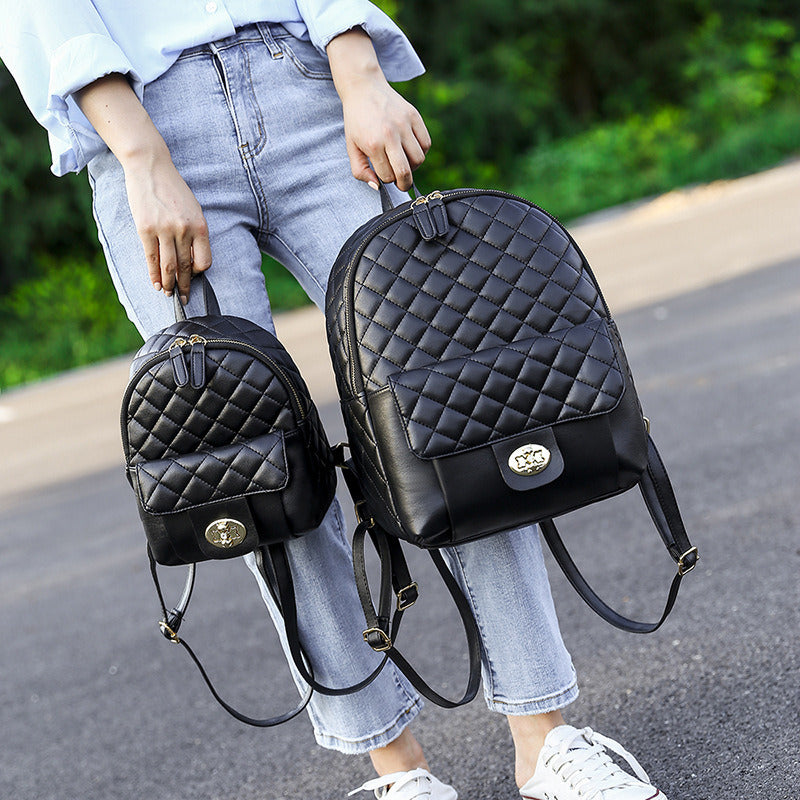 A Doba black leather backpack for men women school college bookbag for student on a white background.