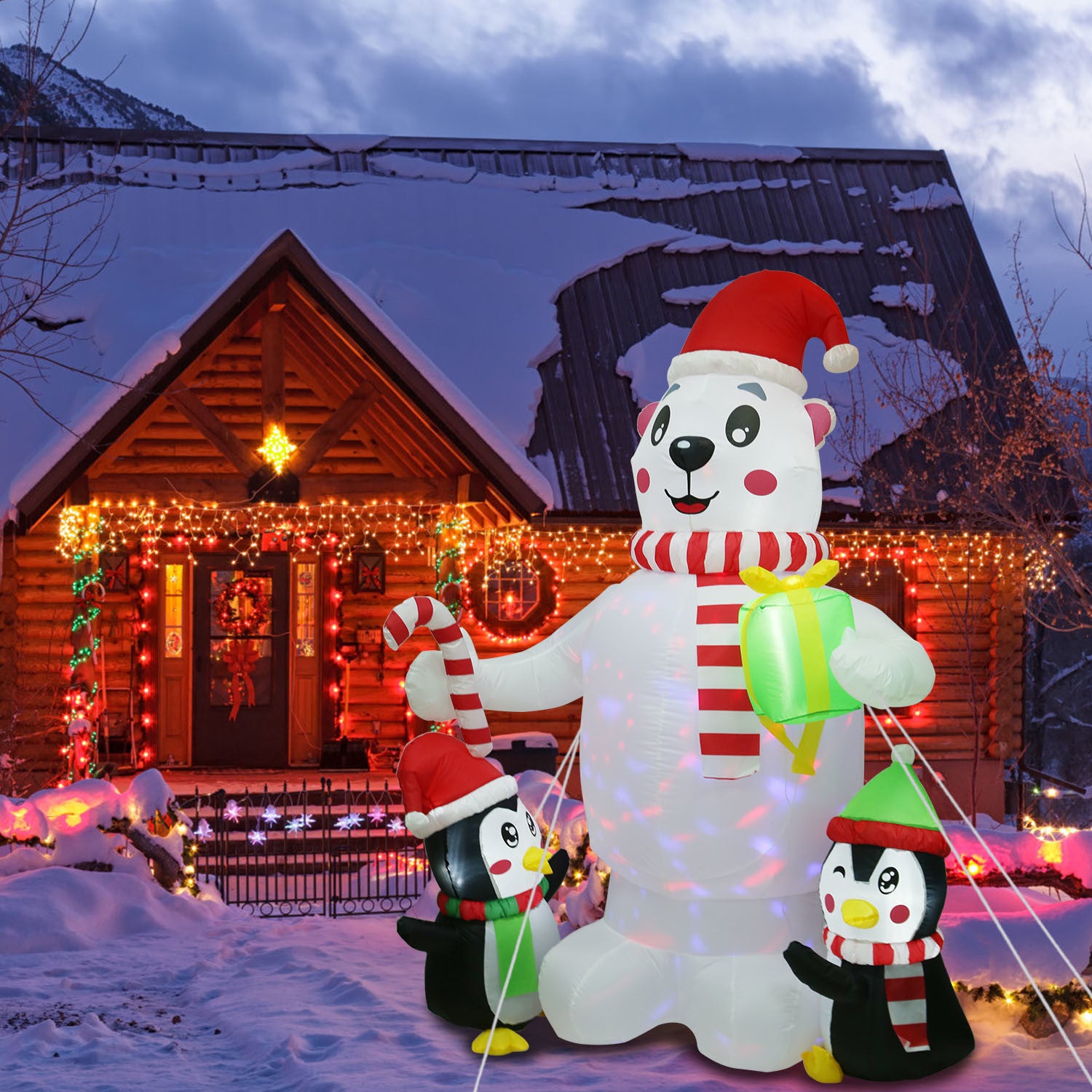 An impressive 5.9FT Christmas Inflatable Outdoor Decoration Polar Bear Gift Box Penguin Blow Up Yard Decoration with LED Light Built-in Air Blower for Winter Holiday Xmas Garden featuring a large inflatable polar bear and penguins in front of a house.