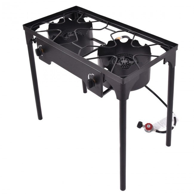 150000 BTU Double Burner Outdoor Stove BBQ Grill connected to a red propane tank, with visible blue flames on the burners, set against a white background.