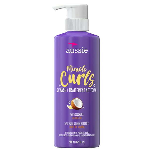 Sentence with Product Name: Aussie Paraben-Free Miracle Curls Co-Wash w/ Coconut & Jojoba Oil For Curly Hair; 16.9 fl oz bottle with pump dispenser, featuring coconut & jojoba oil on the purple label.