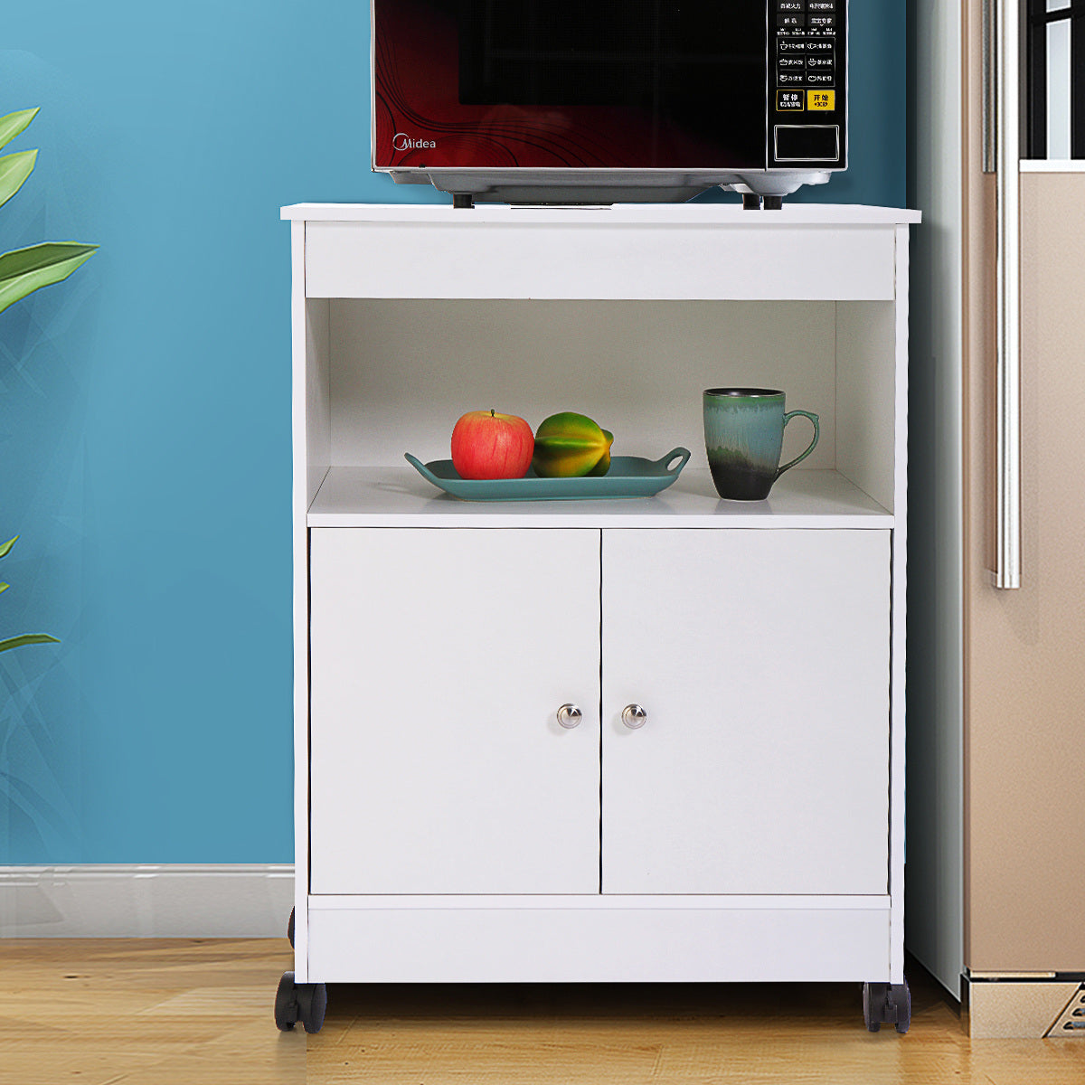 A Wood Kitchen Microwave Cabinet Cart with 4 Universal Wheels and Roomy Inner Space for Home Use, White, compact microwave with storage space, easy to assemble on a cart in a kitchen.
