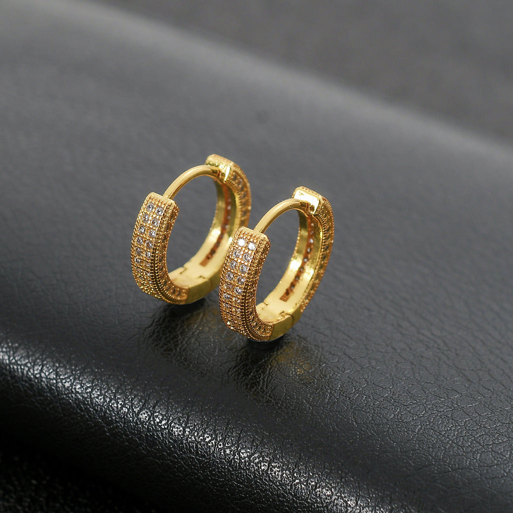 Close-up of a woman's ear wearing a Hoop Earrings Micro Encrusted Zircon Stud Earrings Bling Hip Hop Earrings For Men And Women.